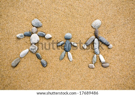 Pictogram.Family from a pebble on sand.