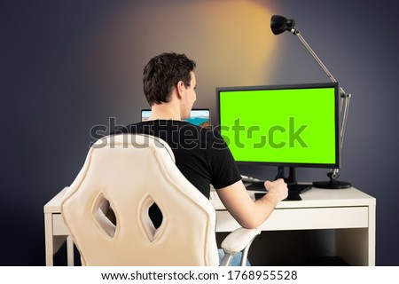 freelance video editor sit on white chair and desk in his office and do some work with graphic tablet