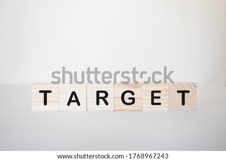 colorful word TARGET alphabet cube. selective focus. Background may have blur effect.