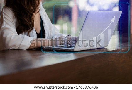 Double exposure of financial graph. Businesswoman hand using laptop computer and stock market graph, business internet technology concept, background toned image blurred.