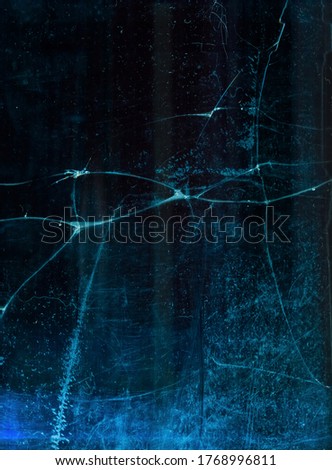 Broken ice texture. Fractured glass. Blue cracked frozen surface with dust scratches.