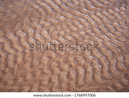 Sand waves texture seen through water