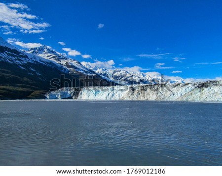View of glacier from Alaska cruise ship. Ice from glacier floating on the ocean.