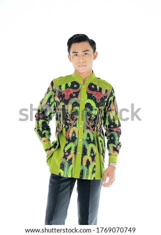 Not Focused Photo  of Young Asian Man wear batik shirt Portrait of charming successful young entrepreneur, smiling broadly with self-assured expression isolated White Background. Indonesian People