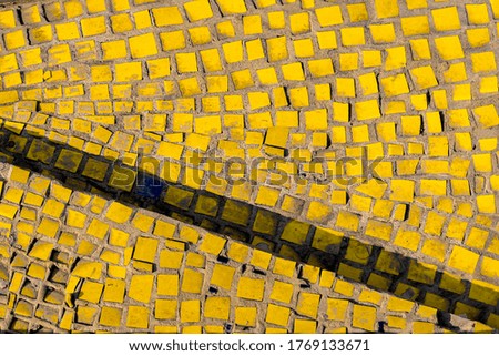 ancient yellow artistic mosaic background. geometric shapes texture, shallow depth of field, selective focus
