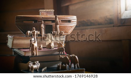Story of Noah's Ark adventure with animals on the Bible and History books, Wood carving doll, christian concept. Royalty-Free Stock Photo #1769146928