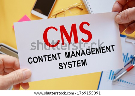 Office desktop - flat lay photo from above. Caption - CMS content management system