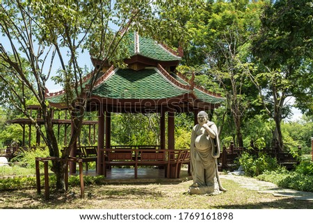 Buddha on the background of a traditional Asian gazebo.