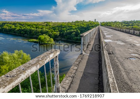 Dilapidated unsafe bridge over river. Abandoned building of emergency condition Royalty-Free Stock Photo #1769218907