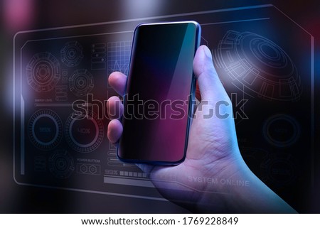 Hand holding black smartphone on dark color background. Futuristic design of digital connection technology. Creativity ideas on virtual screen concept.