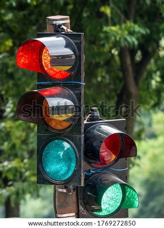 Traffic light against with green blurred background.