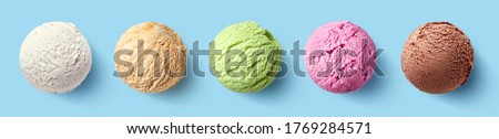 Set of five various ice cream scoops or balls on blue background. Top view. Vanilla, strawberry, caramel, pistachio and chocolate flavor