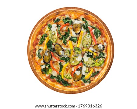 Delicious vegetarian pizza base topped with tomato sauce, spinach, zucchini, aubergine, broccoli, pepper, and mozzarella served on wooden plate and on white background.