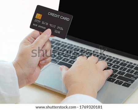 girl left hand holding mock up credit card and searching mock up credit card and laptop using for advertising