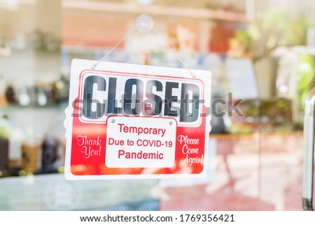 Closed sign on door entrance cafe restaurant or business office store is Temporarily closed due to Coronavirus COVID-19 until the situation improves