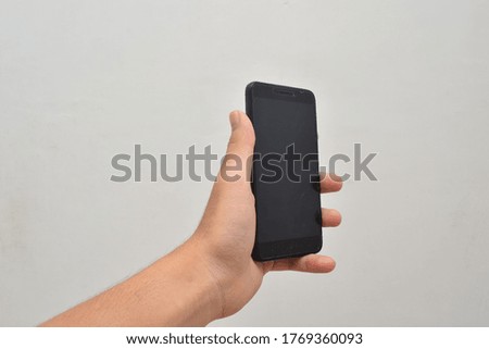 Male hand holding smartphone. Mock up smartphone blank screen easy adjustment with clipping path