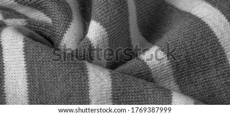Texture, background, pattern, design, fabric from gray and white woolen stripes, woolen knitwear, which is elegant and pleasant to work with. Great for your projects.