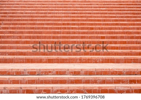 The stairs are covered with red-orange tiles.