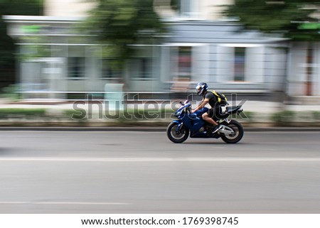 motorbiker on the city street in motion blur Royalty-Free Stock Photo #1769398745