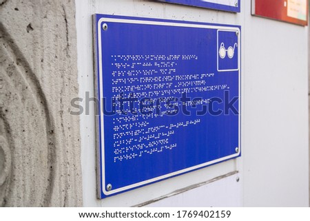 A sign for the blind at the entrance to the organization,