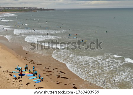 Surfers piling into the North Sea and lessons begin as lockdown gets lifted on Super Saturday.  Royalty-Free Stock Photo #1769403959