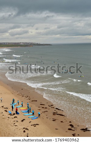 Surfers piling into the North Sea and lessons begin as lockdown gets lifted on Super Saturday.  Royalty-Free Stock Photo #1769403962