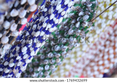 Selective focus on handmade colorful sea shell necklaces jewelry on street market stall in Cox Bazar Bangladesh