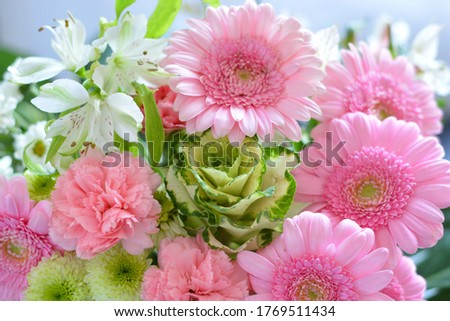 A shallow focus closeup shot of a pink bouquet of Transvaal Daisy, Lily, Rose, Peony flowers