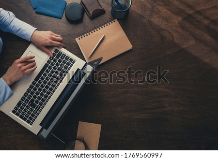 Woman's hands working on a lap top. Businesswoman using laptop

