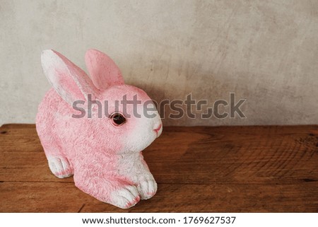 Bunny rabbit with space copy on concrete and wooden background