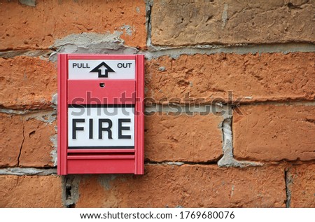 Fire alarm on the brick wall.