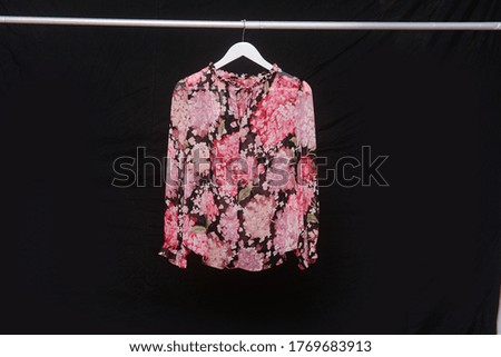 Female floral pattern blouse on hanger-black
