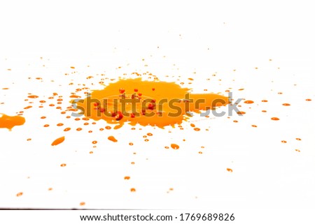 Orange water droplets splashing on a white background