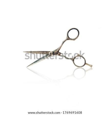 Barber scissors with reflection isolated on a white background. Beauty and fashion. Instruments.