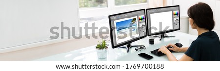 Designer Or Photographer Editing Photos On Multiple Computers