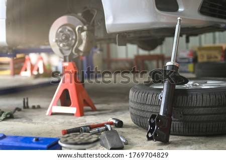 Car shock absorbers replacement service at garage shop. Royalty-Free Stock Photo #1769704829