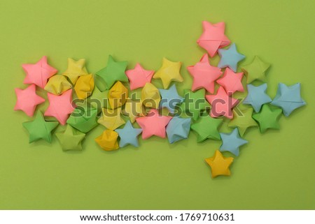 The arrow in the children's style pointing to the right is laid out from multi-colored paper stars. Decor element in layout or scrapbooking.