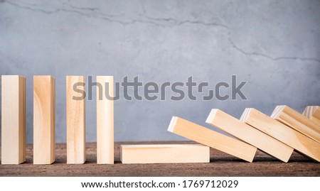 half of the blocks are standing, half have fallen. business concept