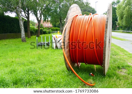 Fiber optic cable laying in the ground, buried cable for faster internet in rural region, city Neustadt, Hanover district, Germany Royalty-Free Stock Photo #1769733086