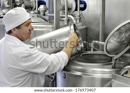 worker on a modern milk factory Royalty-Free Stock Photo #176973407