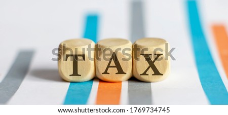 TAX text on chart background. business concept