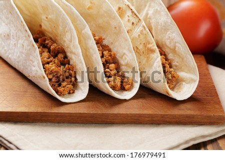 tacos with beef and chilli on old wooden table rustic style