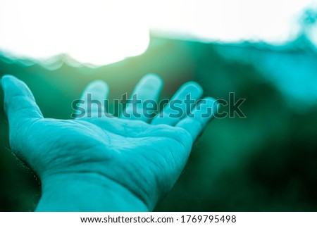 Use hand to touch sun light in the peace morning, freedom lifestyle and tranquility, Pray for wellness, love and faith from holy god, Take meditation in nature with silhouette sky nature light