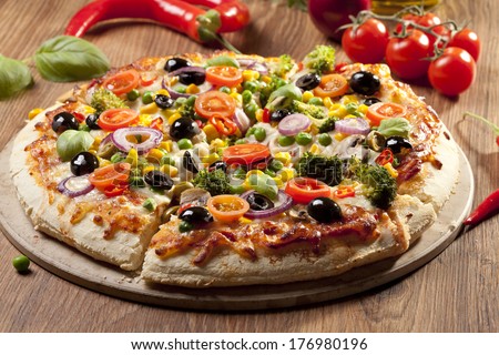 Pizza vegetarian on plate Royalty-Free Stock Photo #176980196