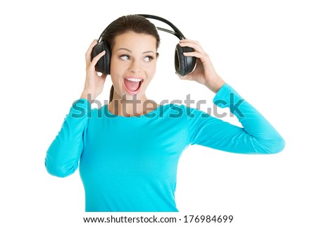 Beautiful woman with headphones, she is listen to the music 