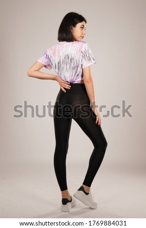 portrait of girl with colorful tshirt and tights in the studio isolated white background