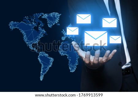 Electronic mail. Businessman demonstrating virtual image of envelopes, closeup