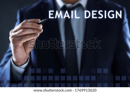 Businessman pointing at phrase EMAIL DESIGN on virtual screen, closeup