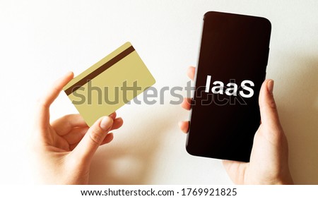 gold card and phone with text disaster recover plan IaaS in the female hands