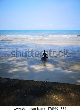 Two children playing in the sea